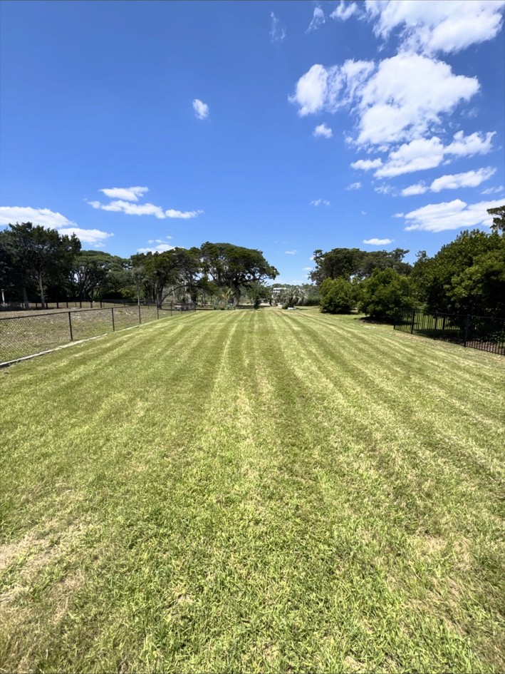 Fresh striped lawn maintained by Island to Inland Lawn Service
